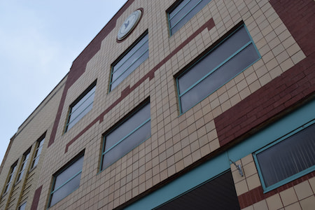 Exterior of large office building with the Sault crane seal high up on the wall.